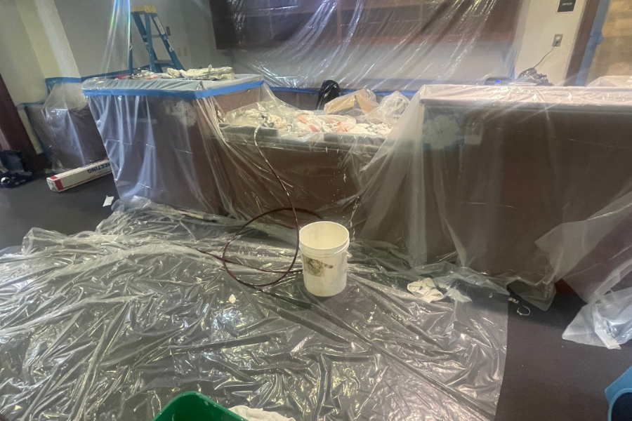 Professional mitigation containment setup with plastic barriers and drying equipment