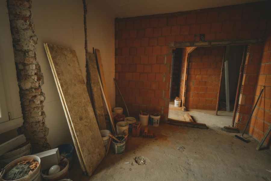 A home mid-renovation with exposed framing and construction materials visible