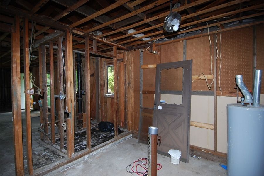 Professional restoration contractor assessing property damage in a home