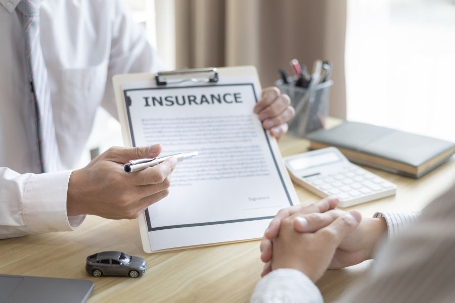 Homeowners insurance policy papers on a desk for claim review